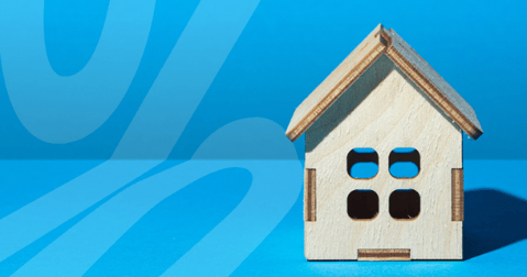 Wooden house on blue background